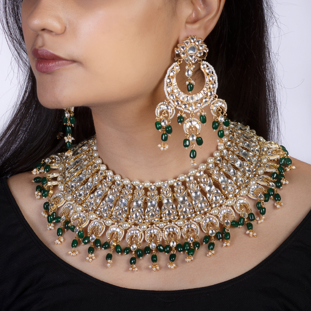 22 K gold plated Kundan necklace studded with white and green pearls.