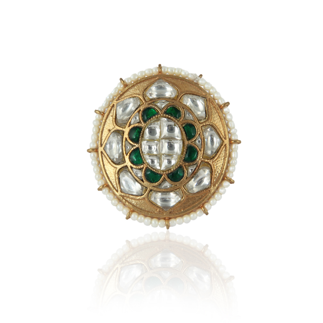 Accented with white and green stones and gold enamel