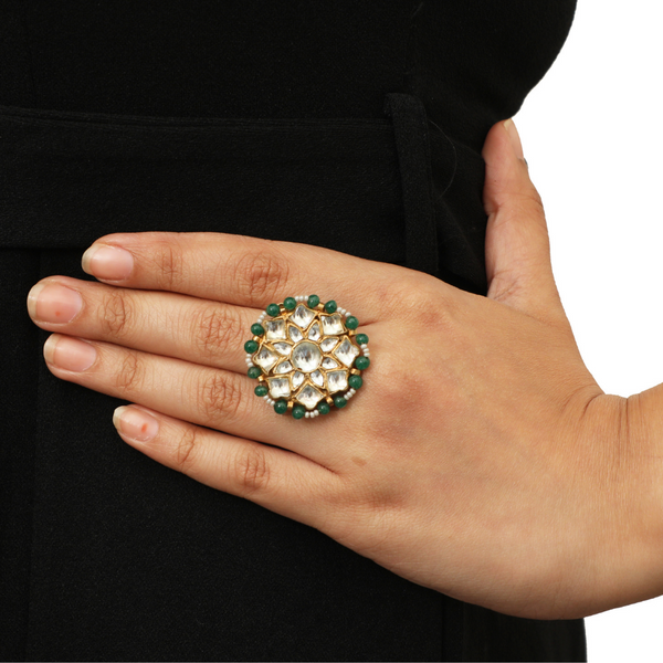 the 22k gold plated flower ring is graced with kundan and light green pearl