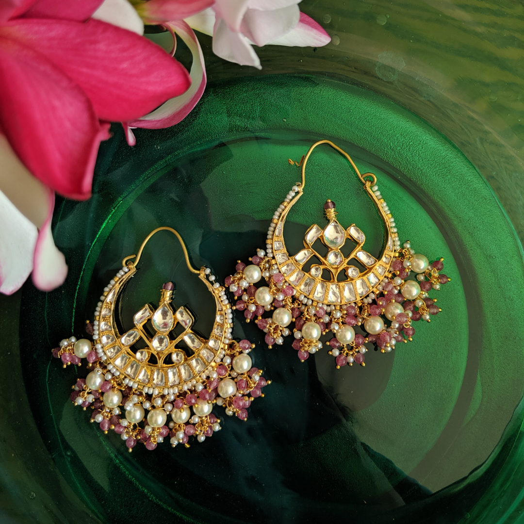 Lovely 22K gold plated Kundan Chandbaali earrings studded with white and pink pearl hangings.