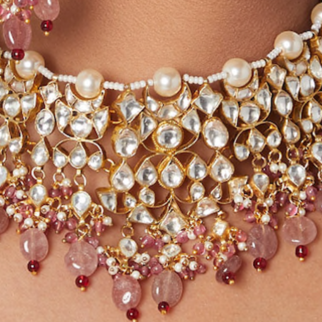 Kundan necklace studded with pearls and pink stone drops.