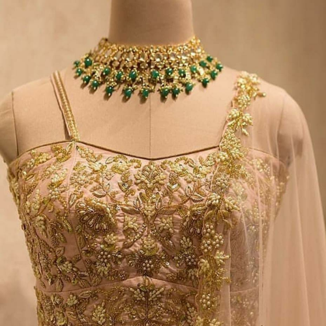 22 K gold plated Kundan necklace studded with white and green pearls and emerald drops.
