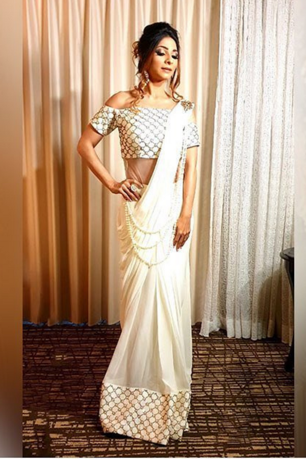 Featuring an off white draped saree 