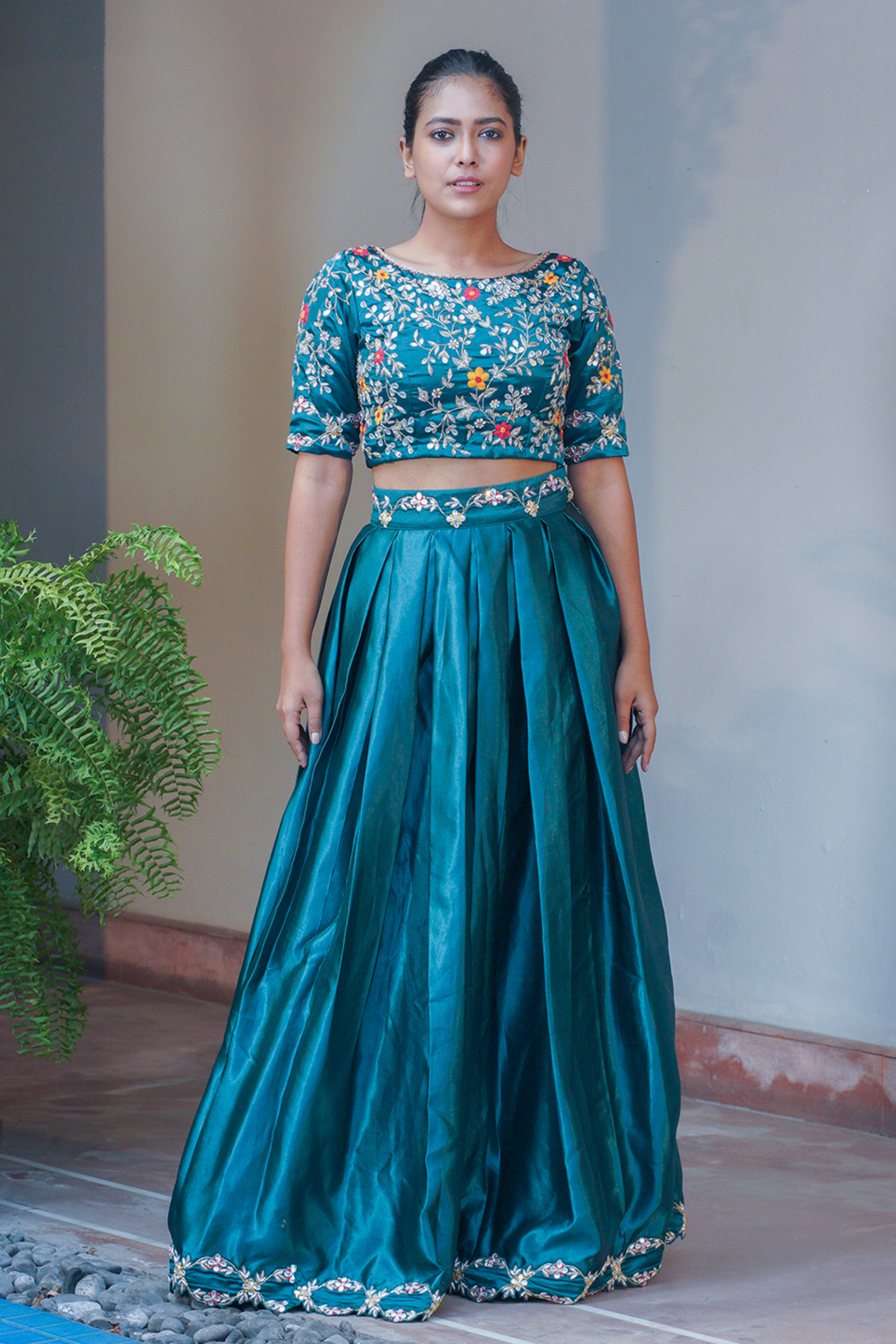teal blue satin lehenga and blouse with silver hand embroidered gotawork.
