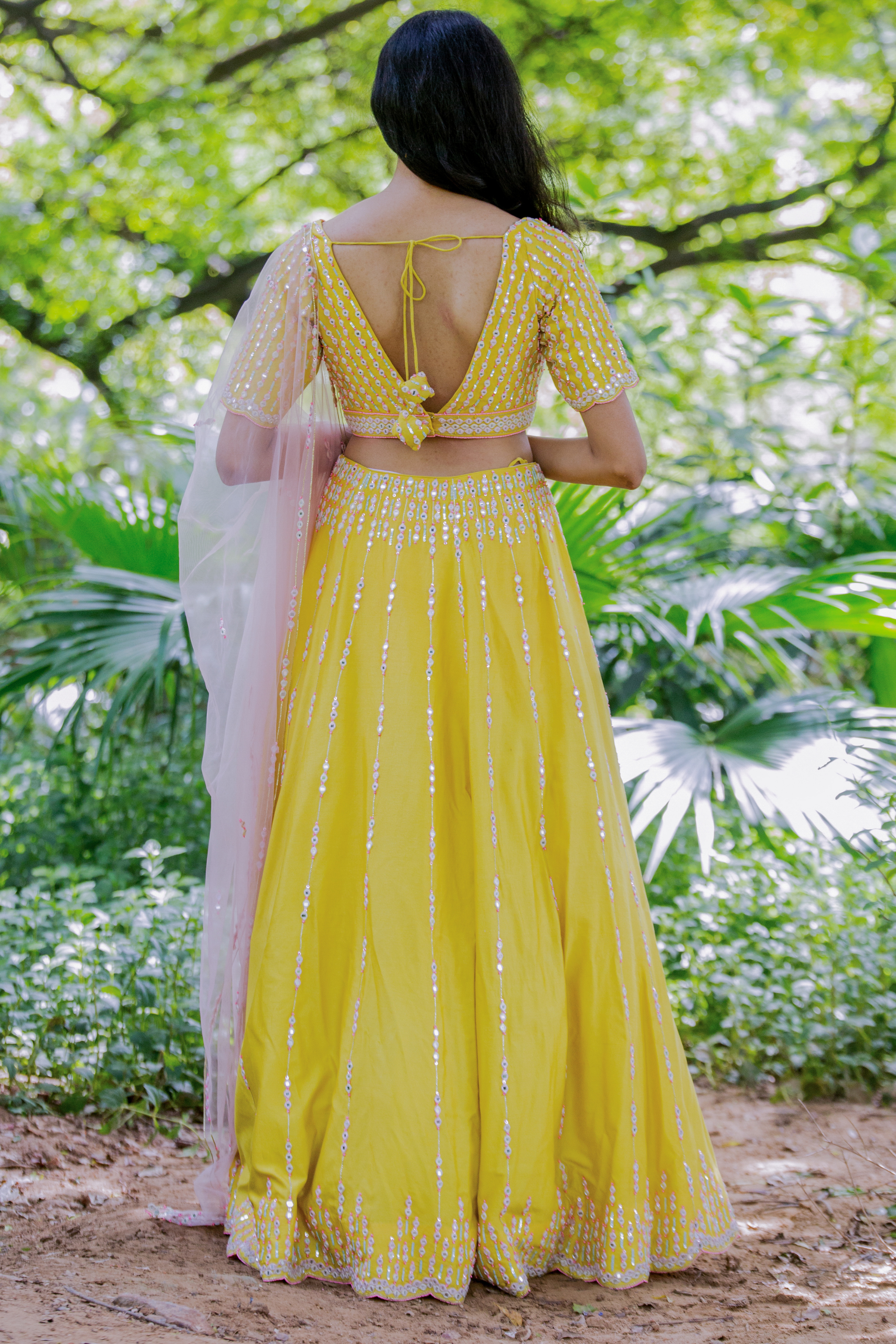 This yellow set features a hand embroidered skirt 