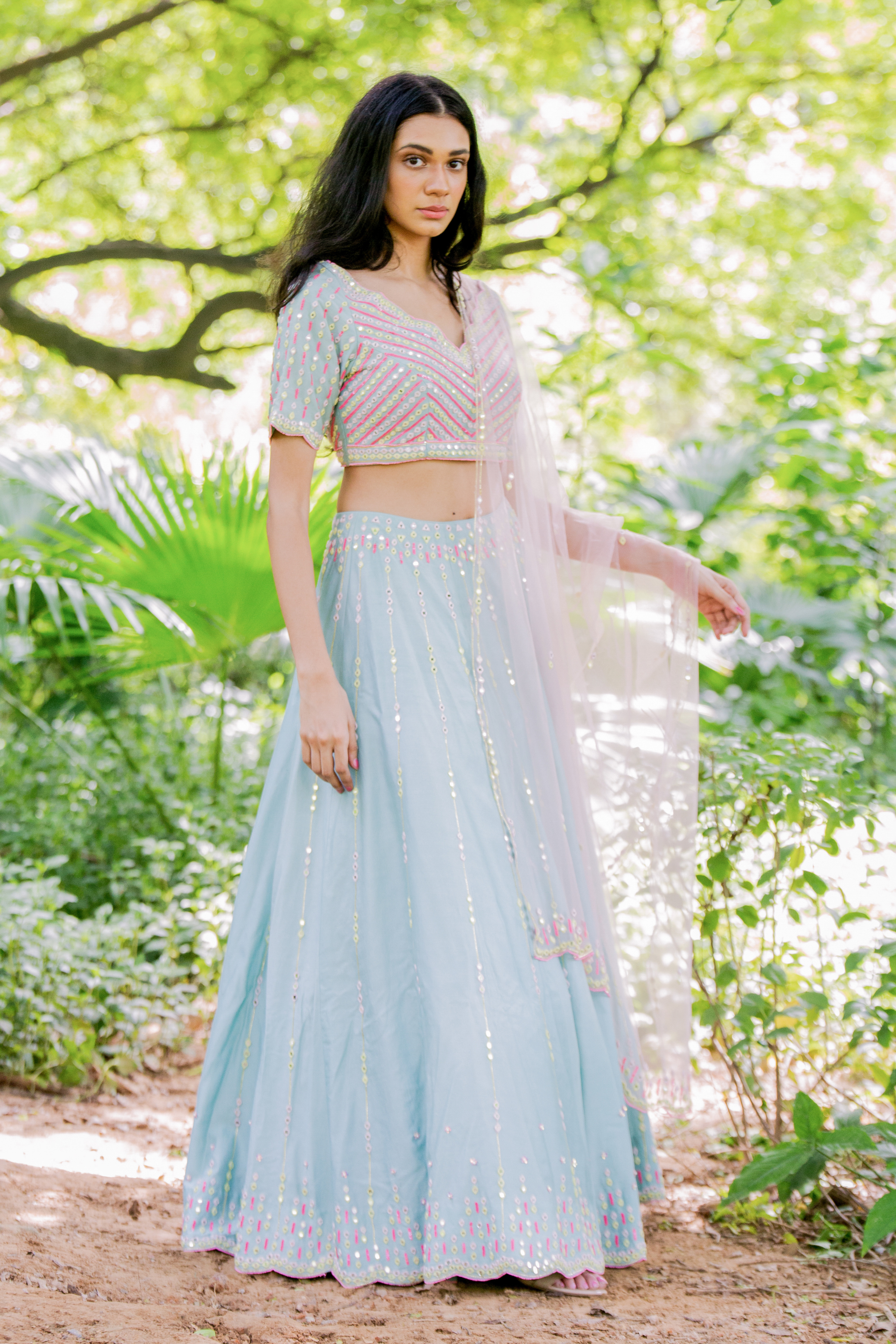 skirt with mirror and  sequins and a delicately embroidered blouse with a blush pink dupatta.