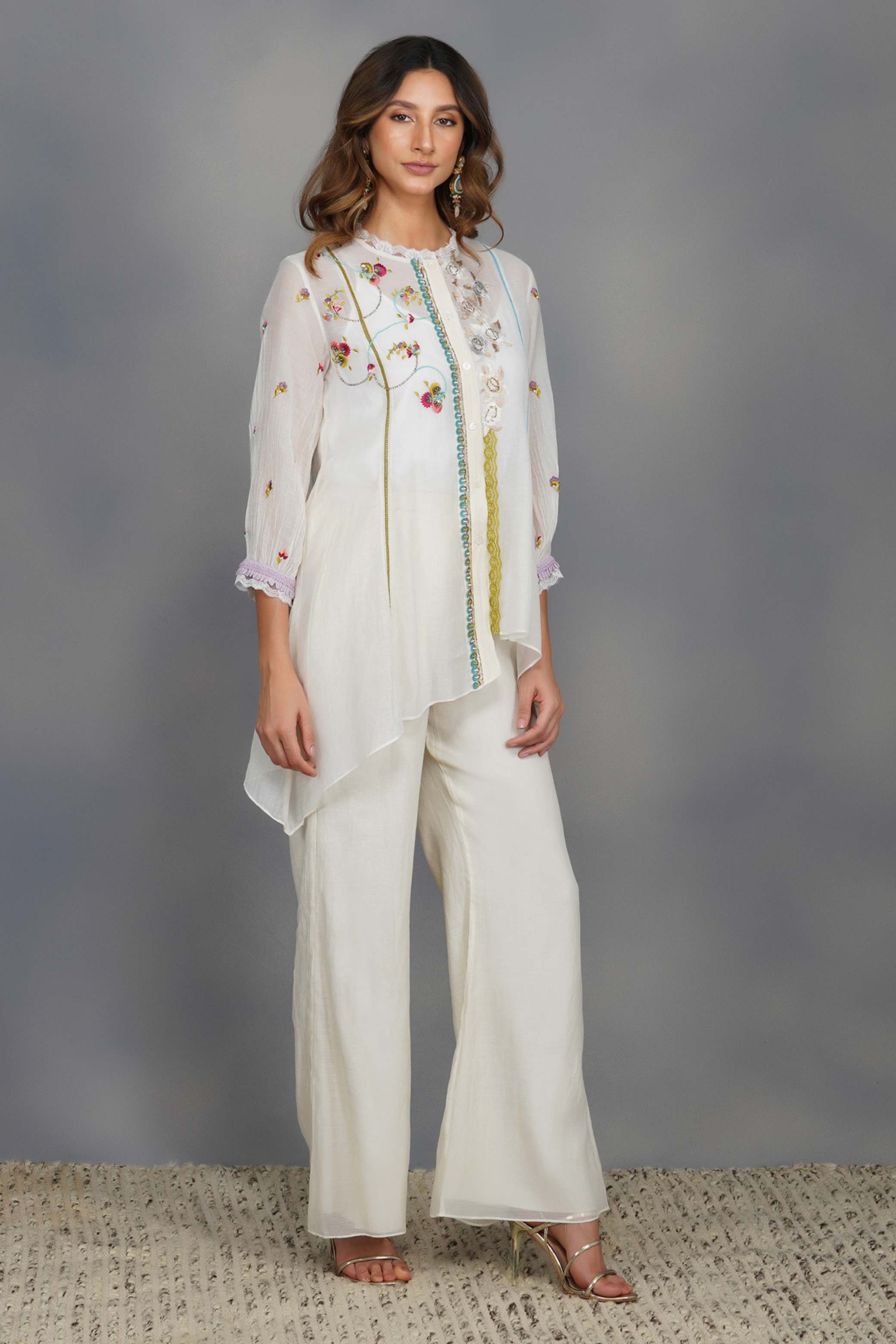 embellished in eclectic motifs and is paired with elasticated flared pants